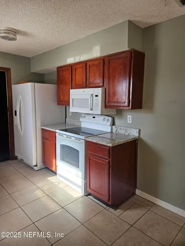 a view kitchen with a sink a counter space and cabinets