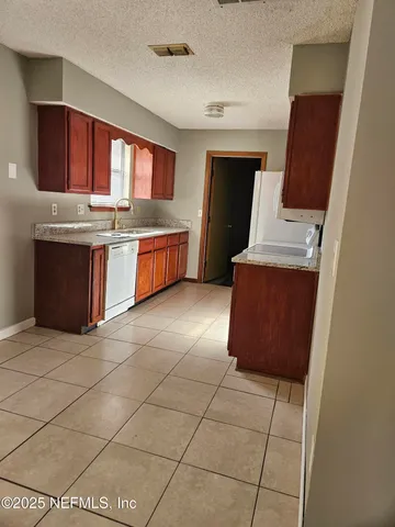 an empty room with windows and ceiling fan