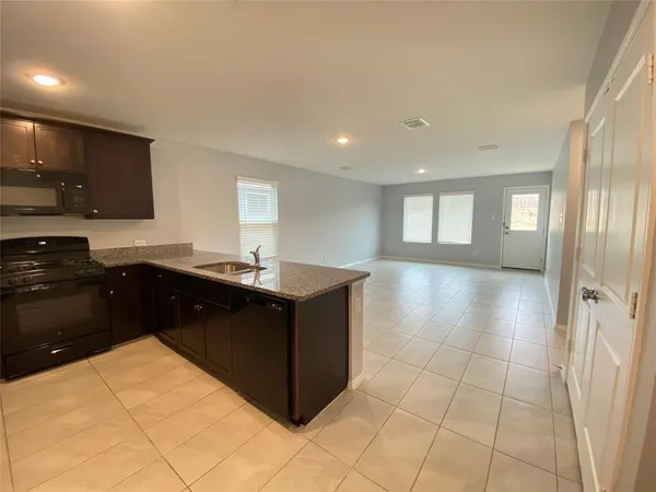 a kitchen with stainless steel appliances a sink stove and cabinets