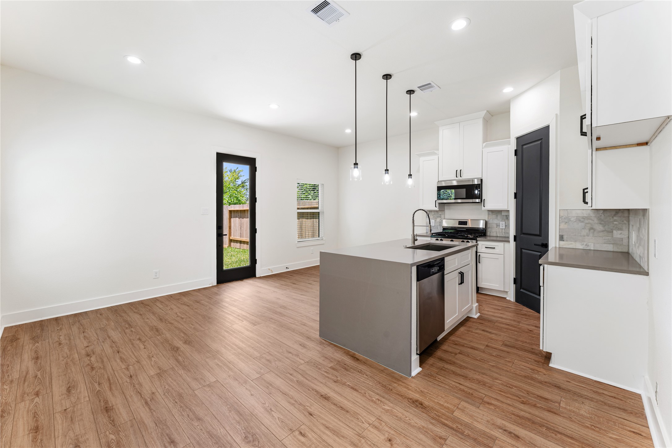 3620 Mt Pleasant Street, Unit A Houston, TX 77021 - Photo 3 of 23 a kitchen with granite countertop a refrigerator stove top oven and sink