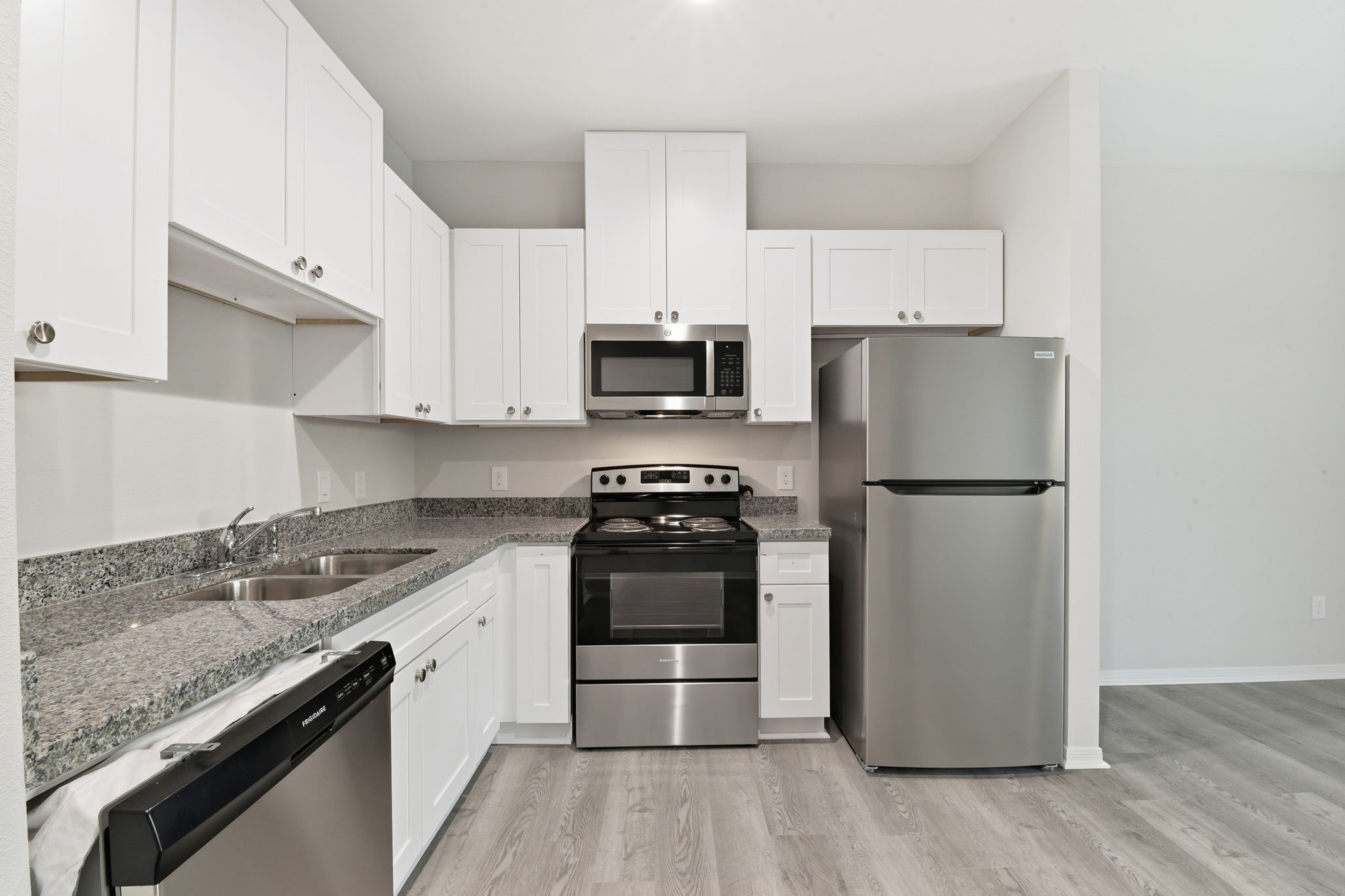 2521 Maple Street, Unit 2521B Liberty, TX 77575 - Photo 11 of 26 a kitchen with a stove a refrigerator and a sink