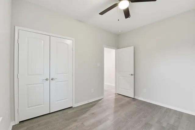 an empty room with a ceiling fan