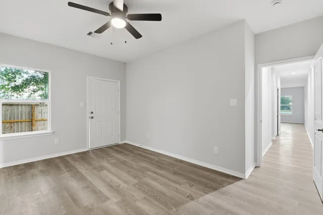 wooden floor in an empty room with a window