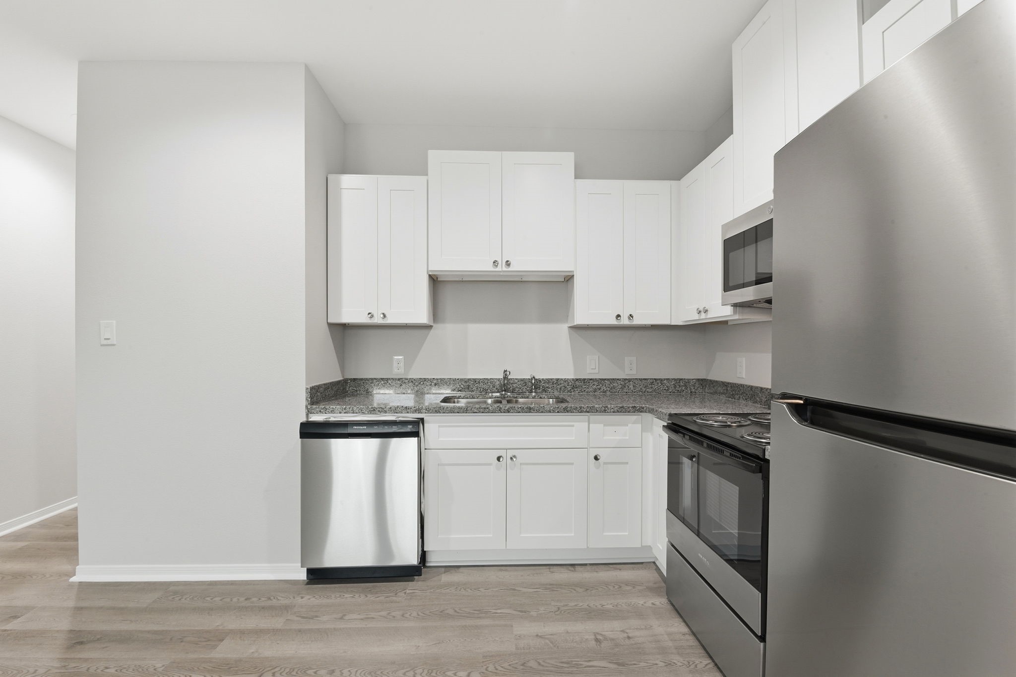 2521 Maple Street, Unit 2521B Liberty, TX 77575 - Photo 10 of 26 a kitchen with stainless steel appliances granite countertop a stove and a sink