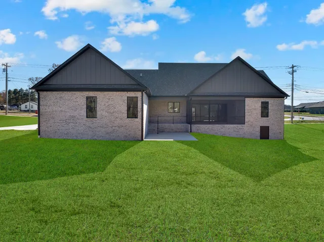 a kitchen with stainless steel appliances granite countertop a sink a stove and a refrigerator