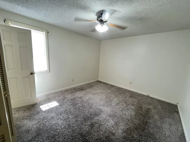 a bathroom with a shower a toilet and a sink