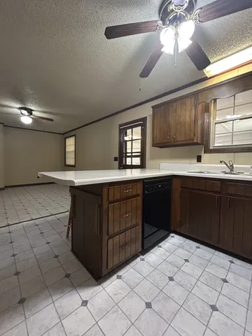 a kitchen with stainless steel appliances a sink and cabinets