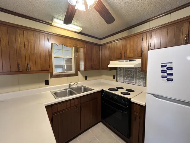 a kitchen with a sink and a stove top oven