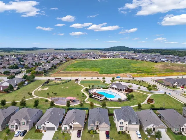 an aerial view of residential houses with outdoor space
