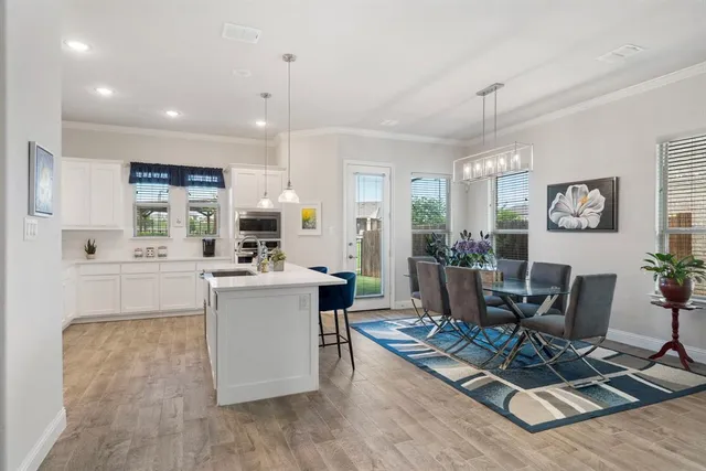 a living room with furniture a dining table and kitchen view
