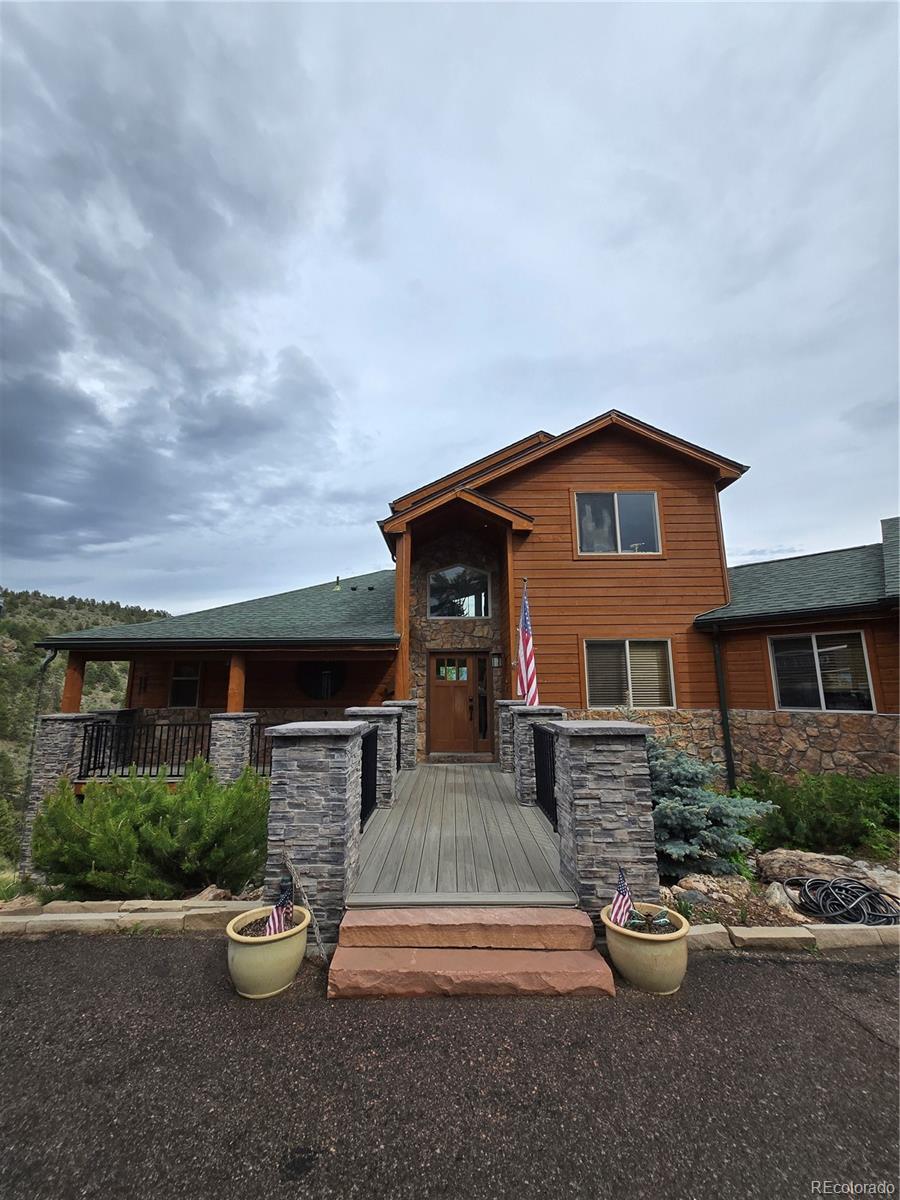 a view of a house with backyard and sitting area
