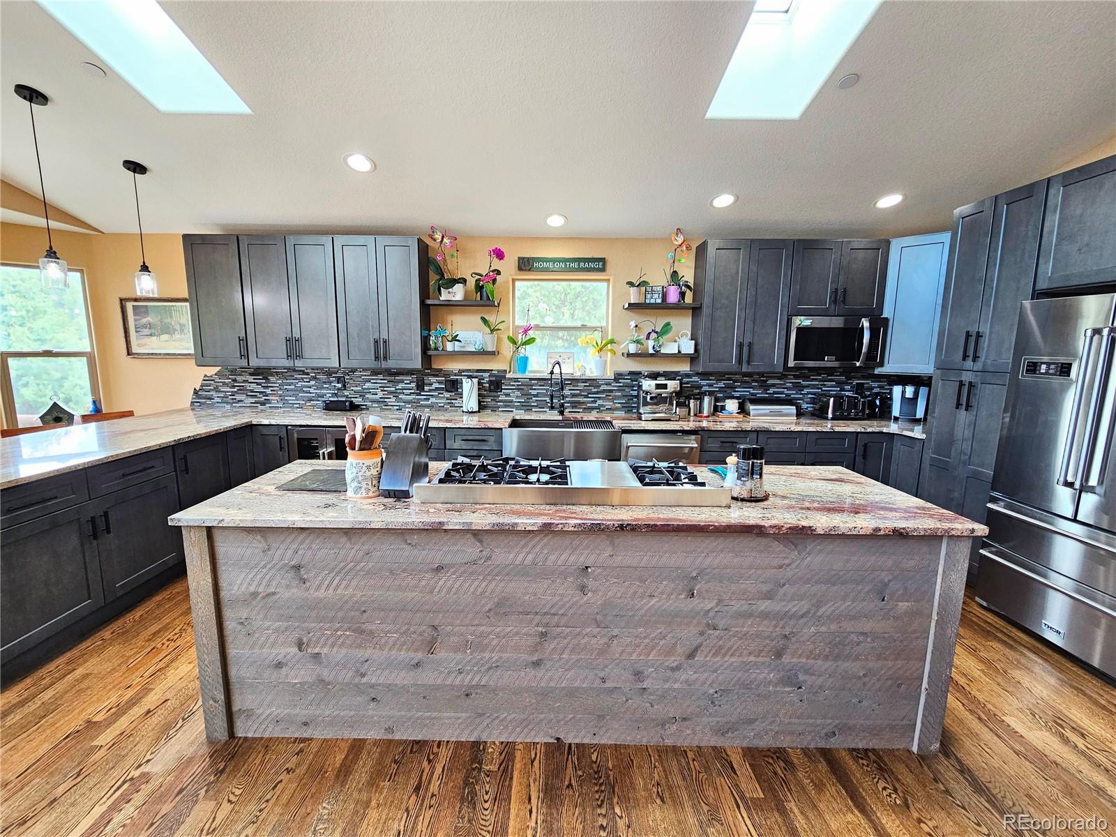 14514 Reserve Road Pine, CO 80470 - Photo 12 of 31 a kitchen with stainless steel appliances granite countertop a stove a sink and a refrigerator