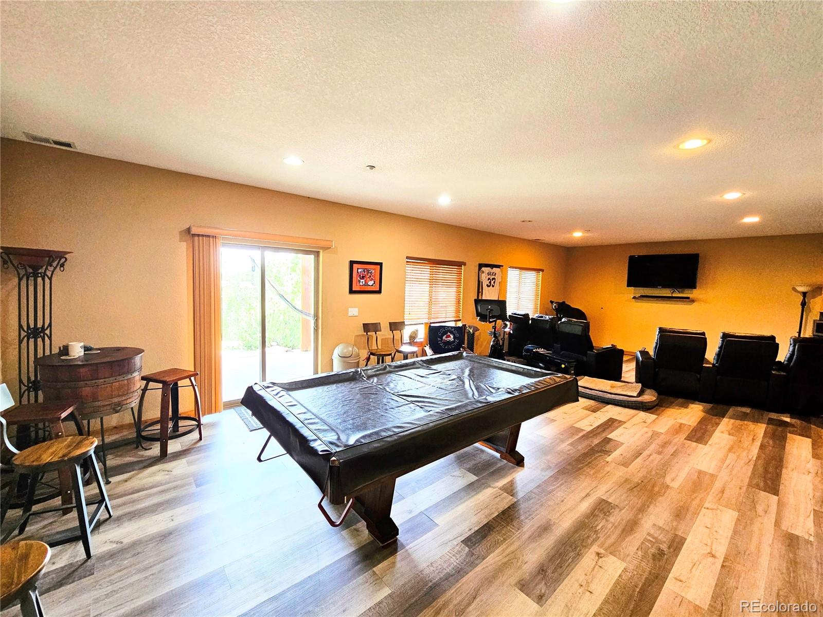 14514 Reserve Road Pine, CO 80470 - Photo 23 of 31 a living room with furniture and a flat screen tv