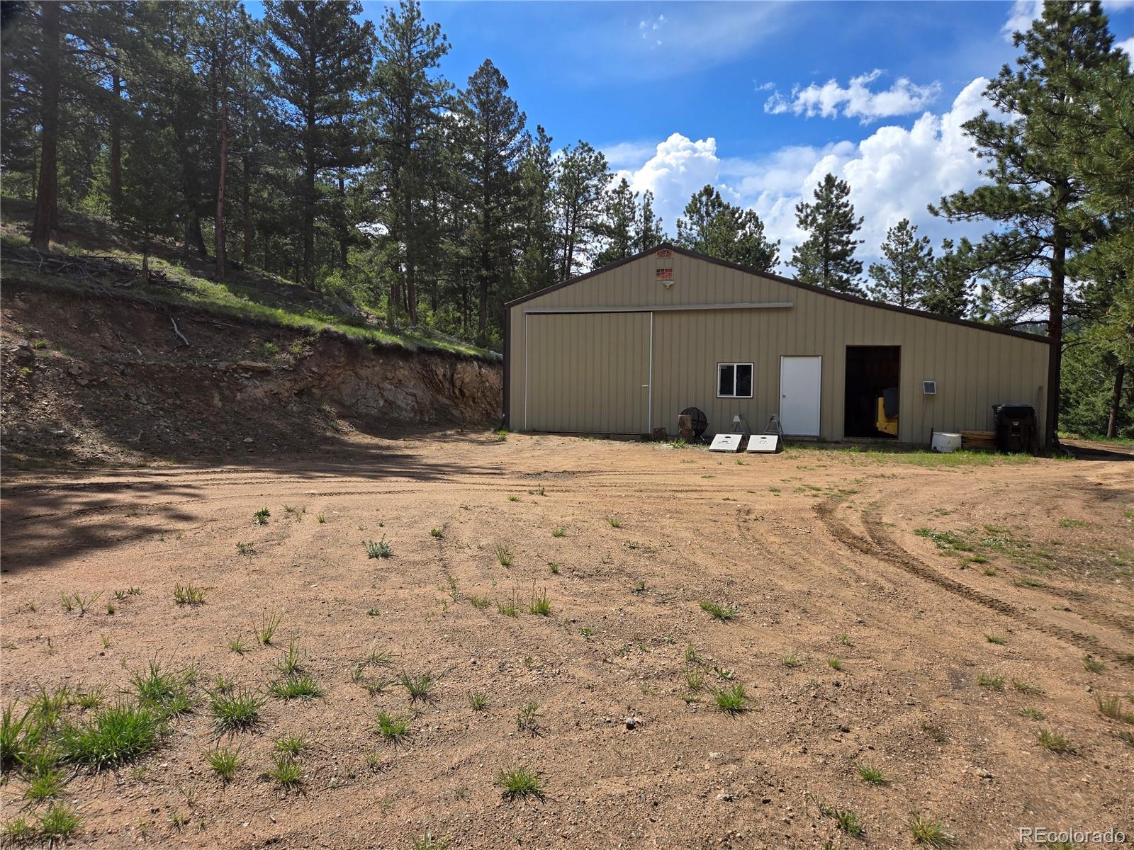 14514 Reserve Road Pine, CO 80470 - Photo 28 of 31 a large house with a large tree