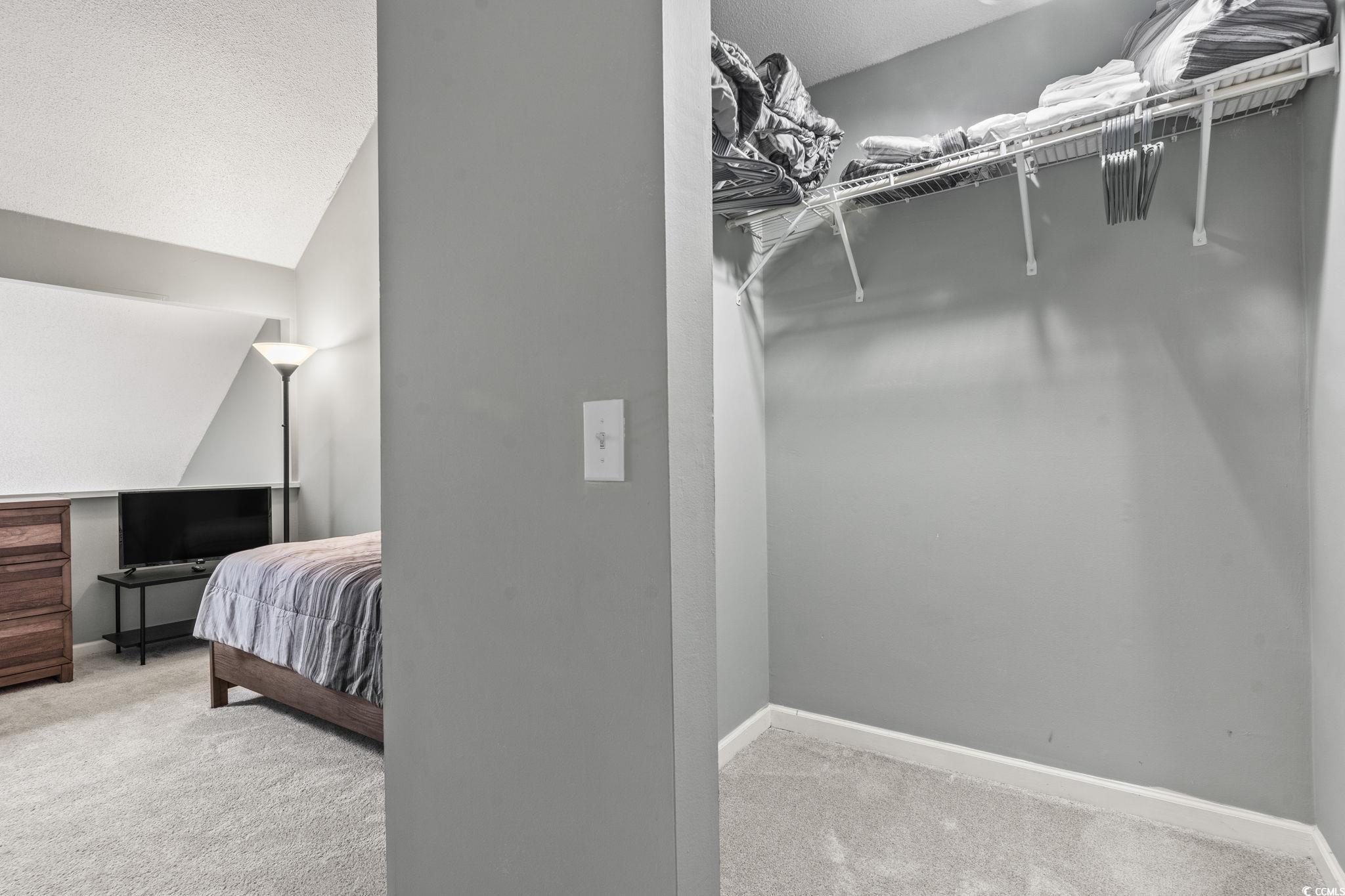 416 Cambridge Circle, Unit H5 Murrells Inlet, SC 29576 - Photo 25 of 28 Kitchen with white cabinetry, a textured ceiling,