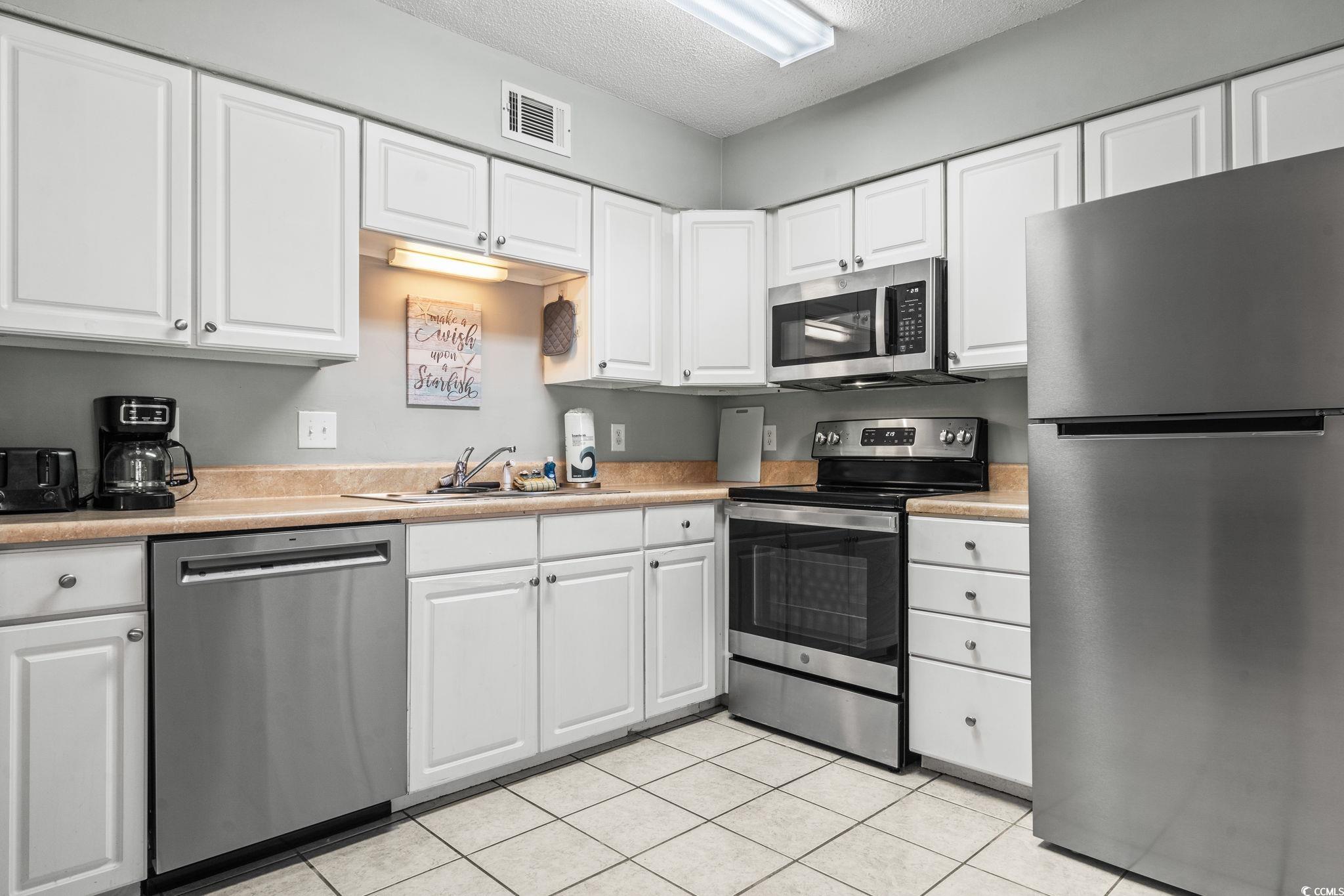 416 Cambridge Circle, Unit H5 Murrells Inlet, SC 29576 - Photo 3 of 28 Kitchen featuring light tile patterned floors, sin