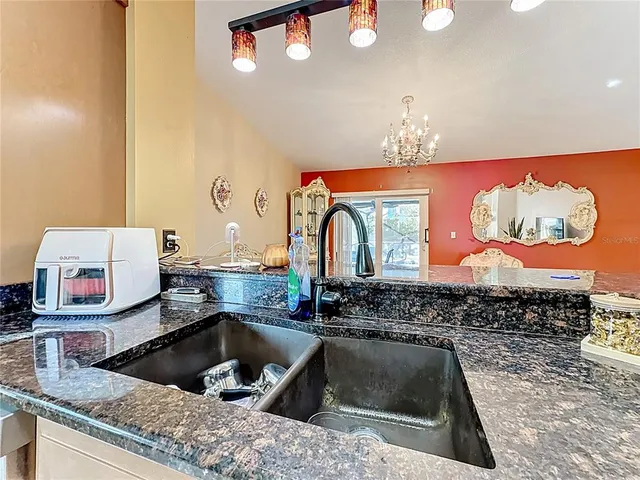 a kitchen with stainless steel appliances granite countertop a sink and a granite counter tops