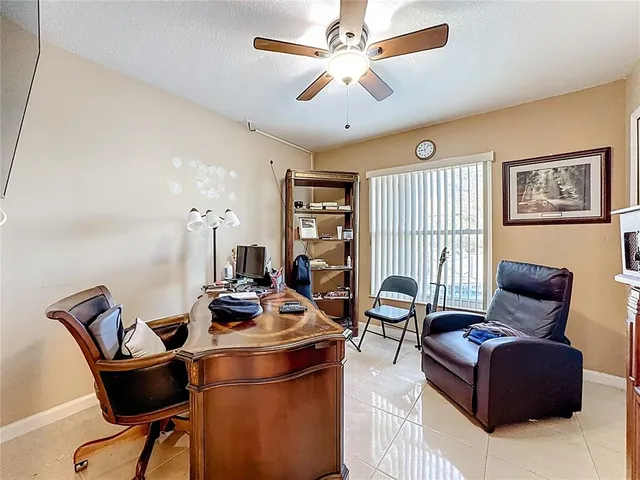 a living room with furniture a chandelier and a flat screen tv