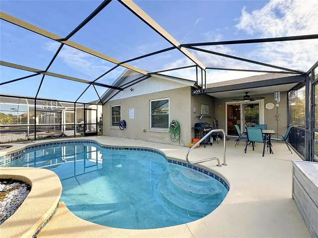 a view of a dining room with furniture a chandelier and wooden floor