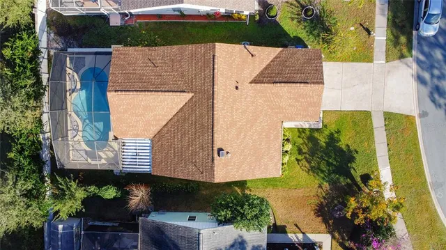 an aerial view of residential house with outdoor space and trees