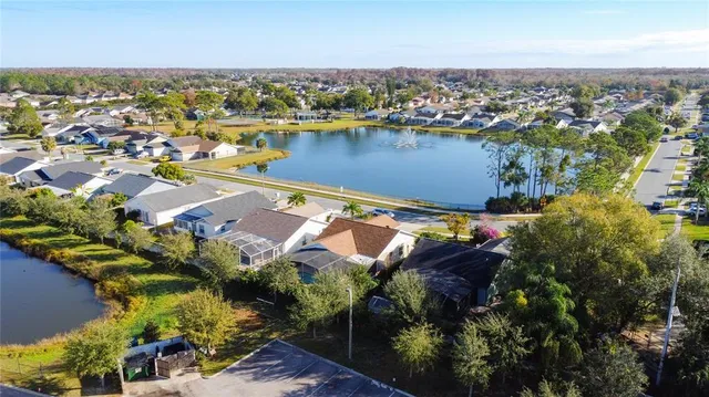 an aerial view of residential houses with outdoor space and river