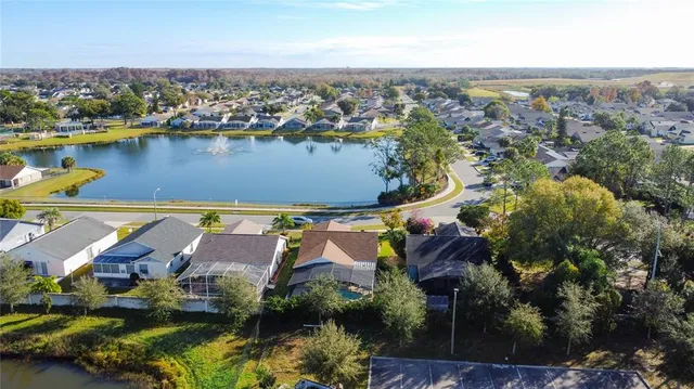 an aerial view of residential houses with outdoor space and river