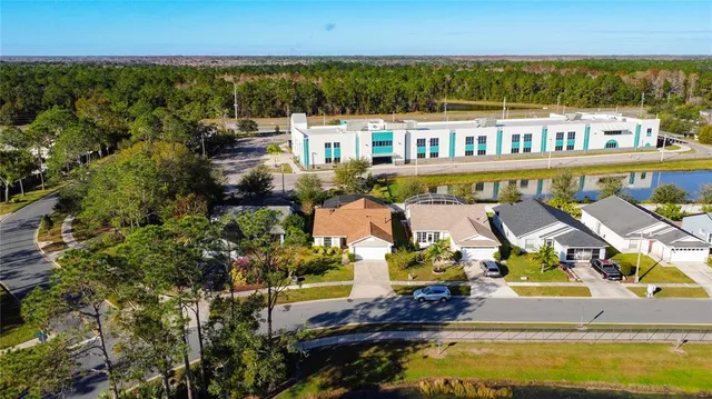 an aerial view of a house with a swimming pool yard and outdoor seating