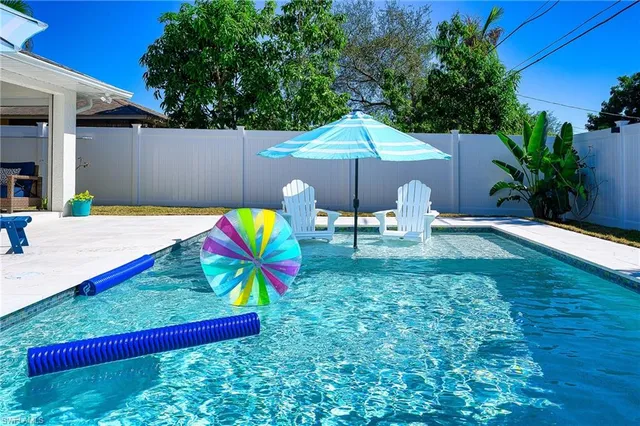 a view of a backyard with a table and chairs