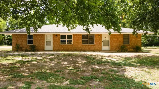 a backyard of a house with large trees