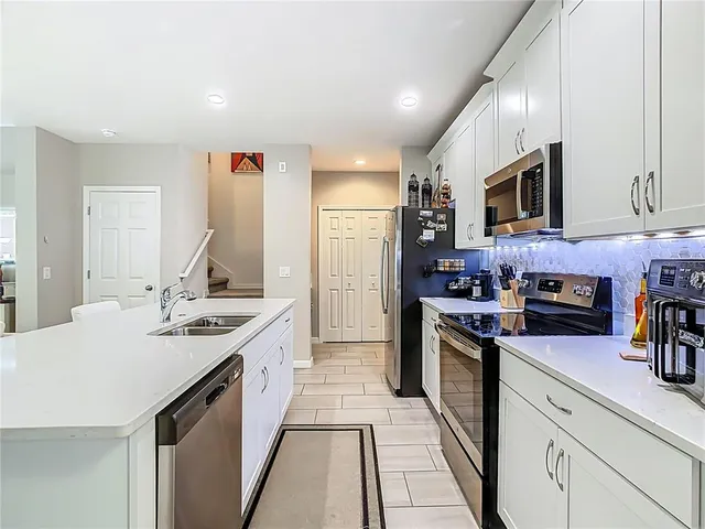 a kitchen with stainless steel appliances kitchen island granite countertop a sink and cabinets
