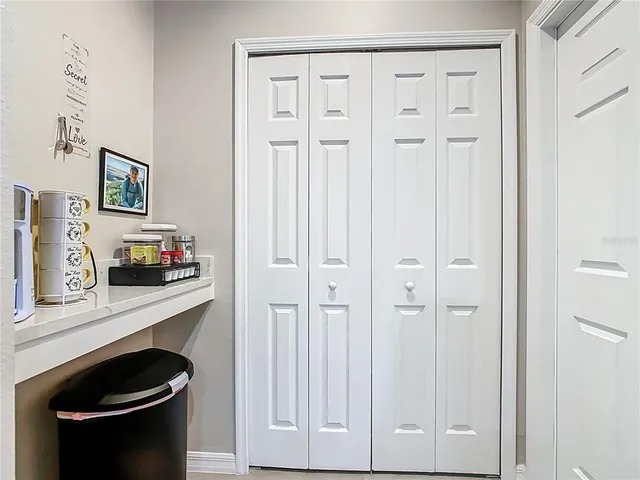 a aerial view of a house with a yard and large trees