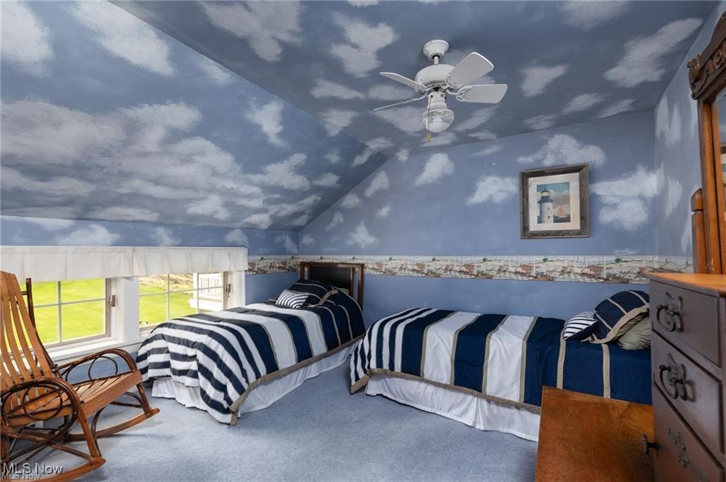 644 Riverside Drive Painesville, OH 44077 - Photo 19 of 48 Carpeted bedroom with wallpapered walls, lofted ceiling, a ceiling fan, and a wainscoted wall
