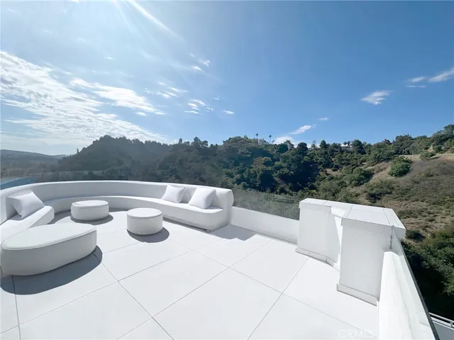 a view of a terrace with couches and sky view