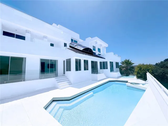 a view of a house with swimming pool and porch