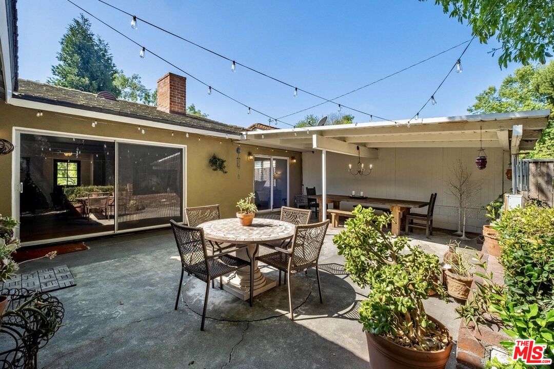 49 Ranchview Road Rolling Hills Estates, CA 90274 - Photo 36 of 49 a view of a patio with table and chairs and potted plants
