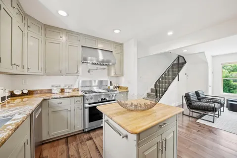 a kitchen with a stove a sink and a refrigerator