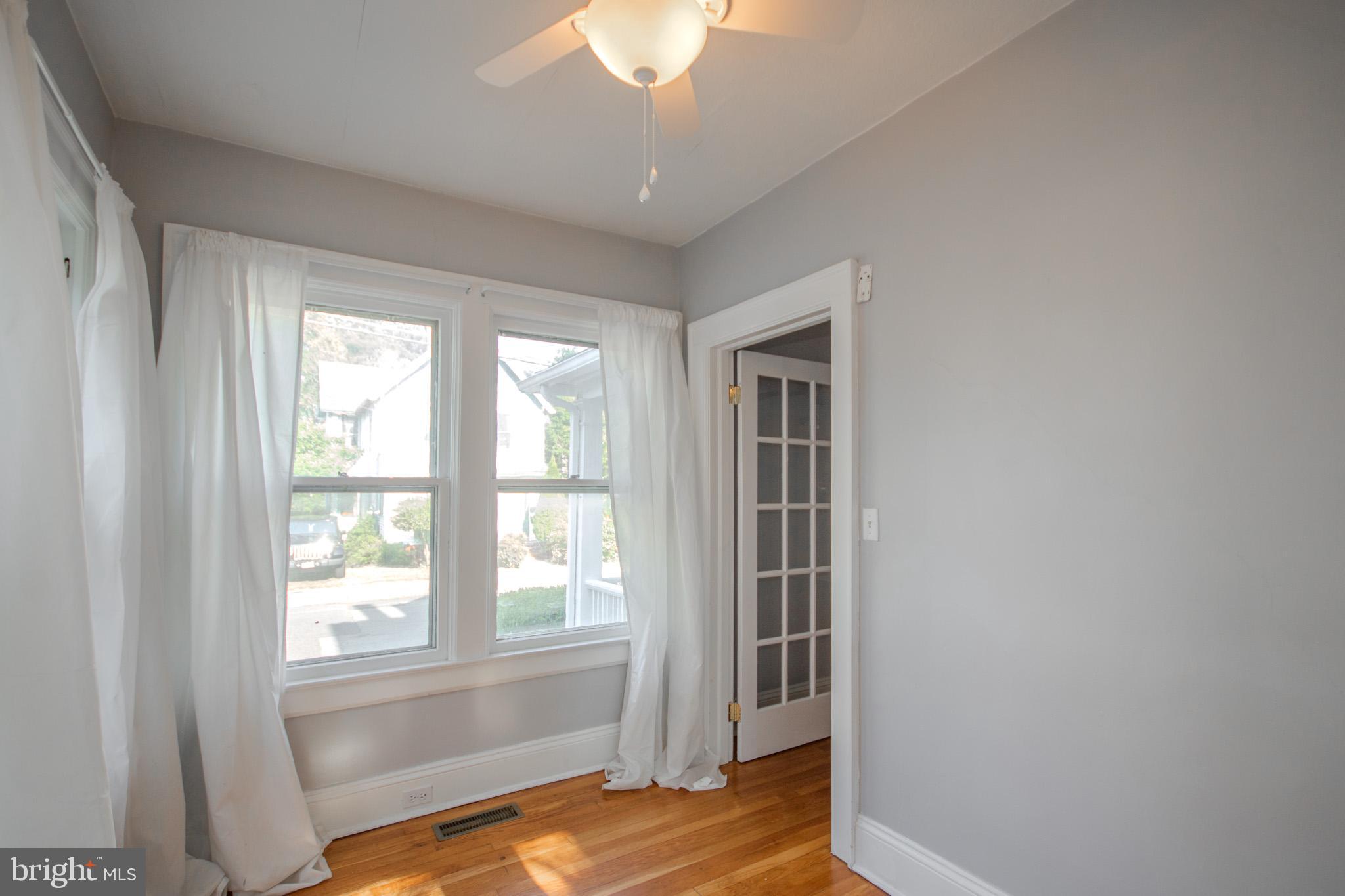 309 Gay Street Salisbury, MD 21801 - Photo 14 of 54 a view of a bedroom with wooden floor and windows