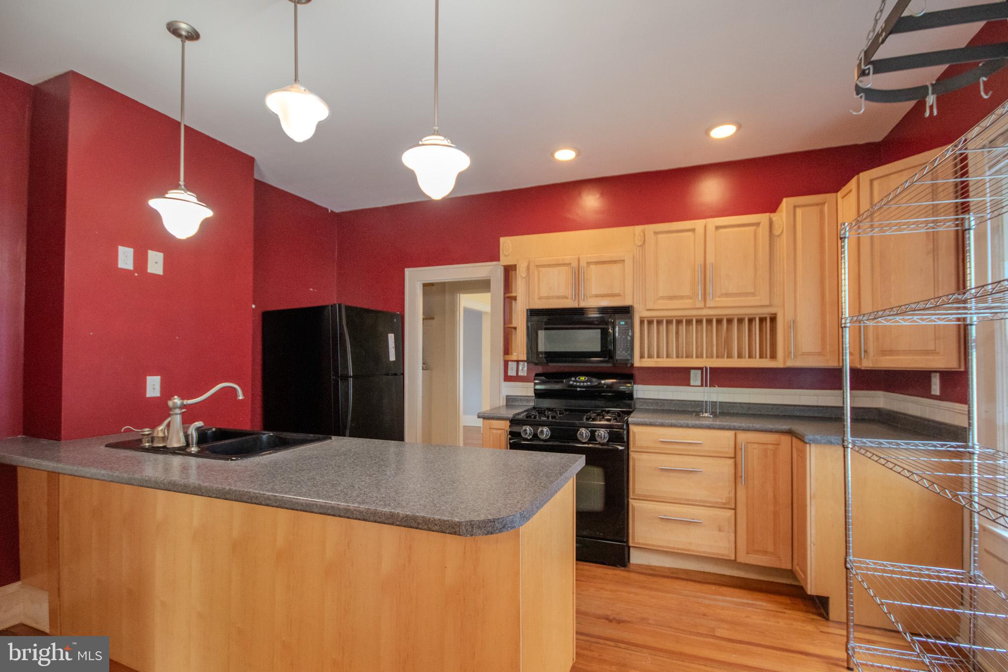 309 Gay Street Salisbury, MD 21801 - Photo 17 of 54 a kitchen with stainless steel appliances granite countertop a sink a stove and a refrigerator