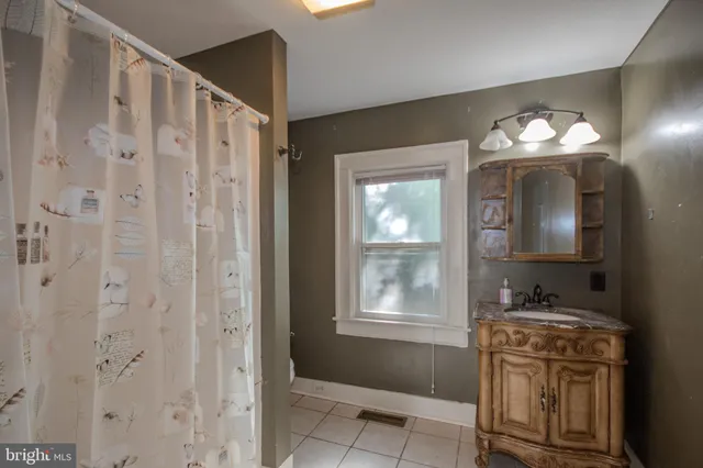 a bathroom with a sink vanity and a mirror
