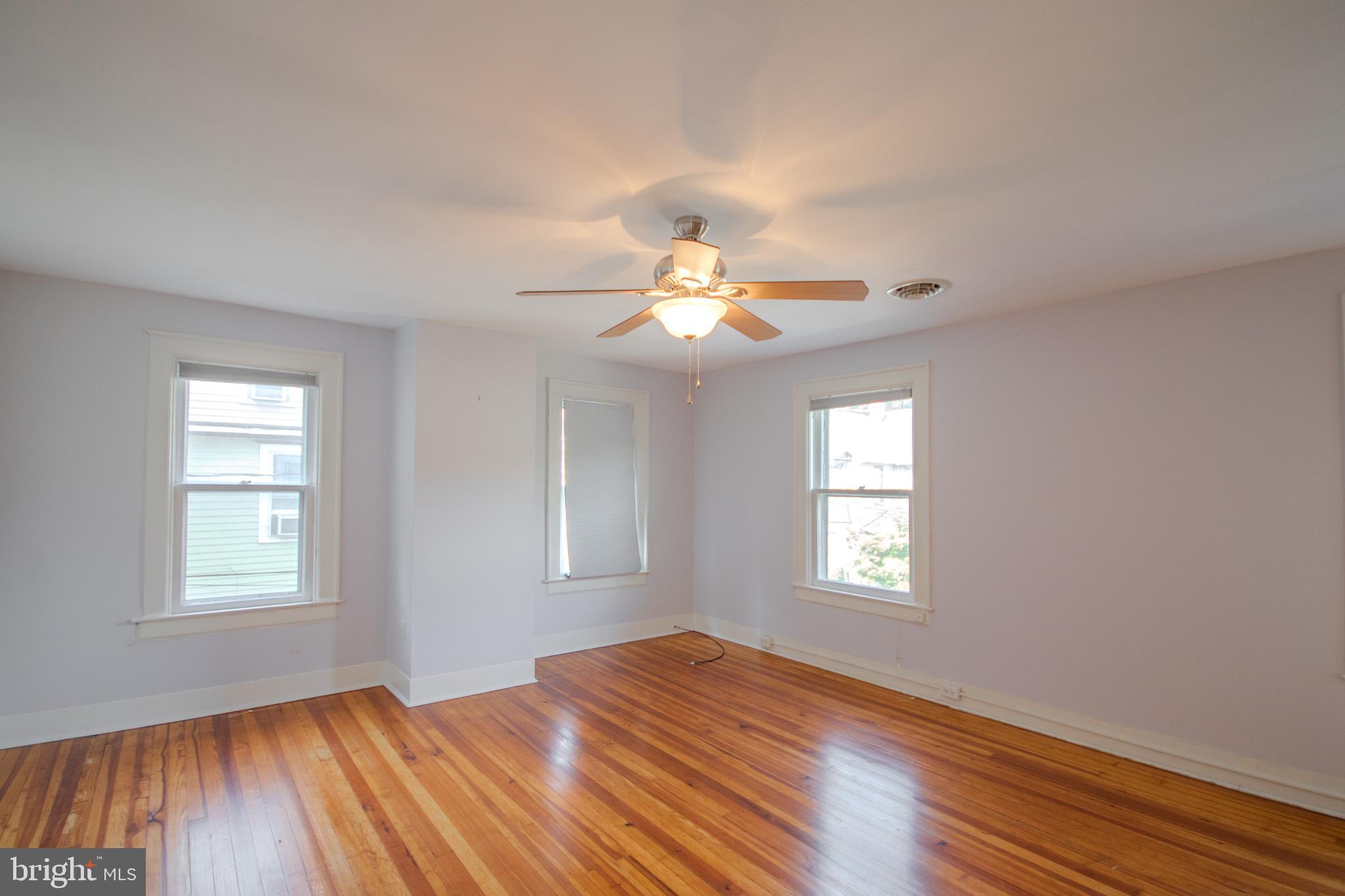 309 Gay Street Salisbury, MD 21801 - Photo 24 of 54 a view of an empty room with wooden floor and a window