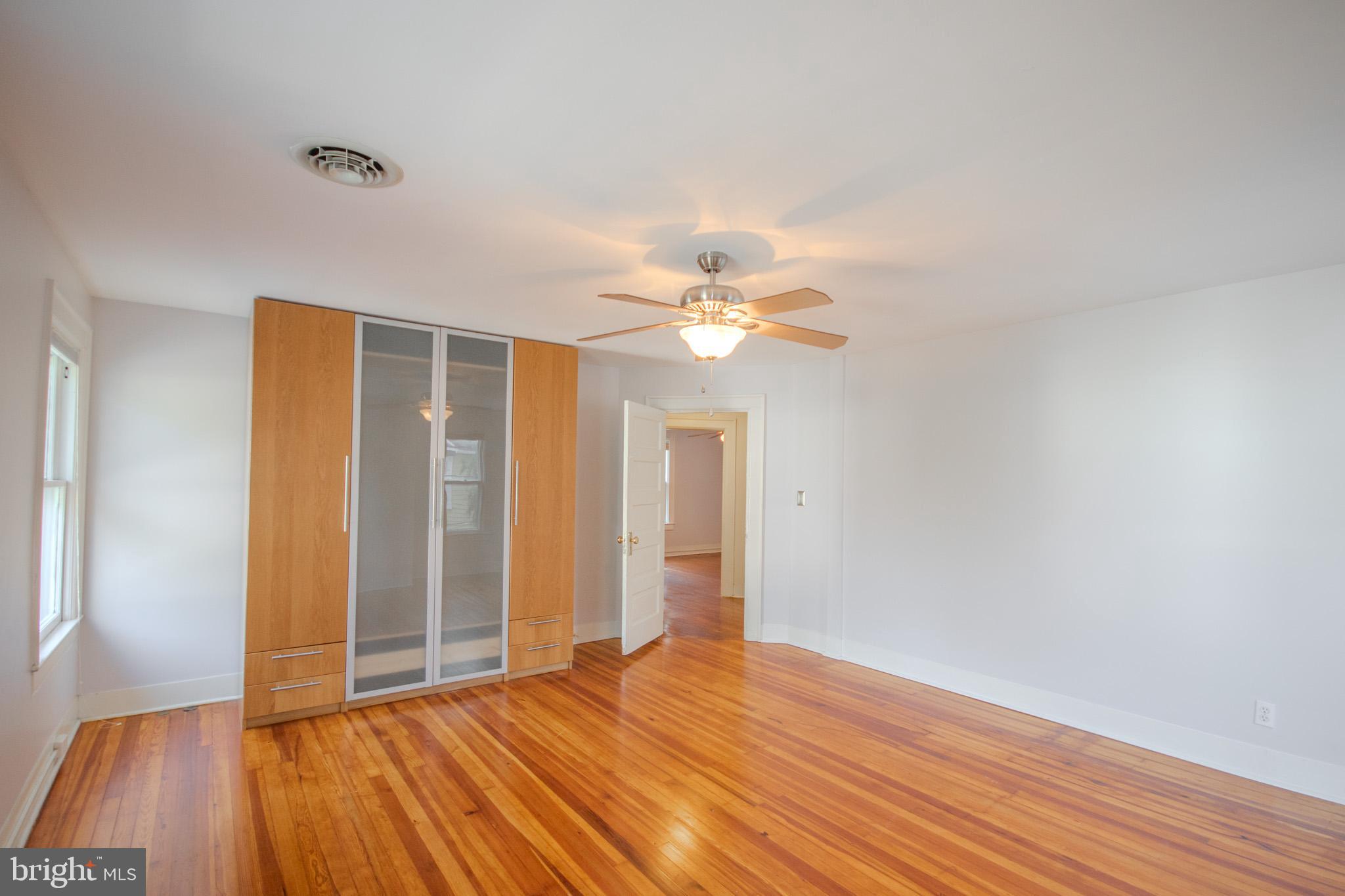 309 Gay Street Salisbury, MD 21801 - Photo 26 of 54 a view of an empty room with wooden floor and a window