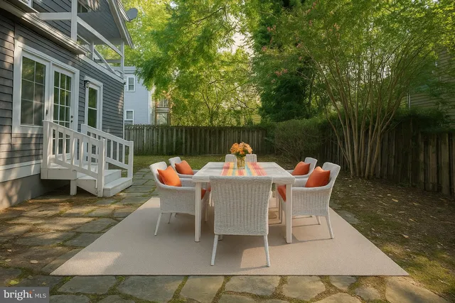 a view of backyard of house with green space