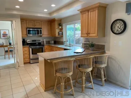 a view of a kitchen with granite countertop a table and chairs