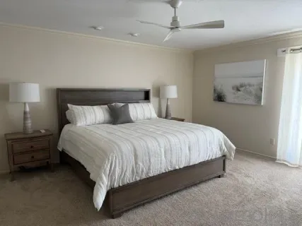 a large bed sitting in a bedroom next to a lamp