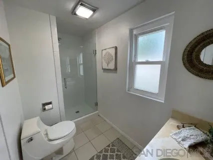 a bathroom with a toilet sink and shower