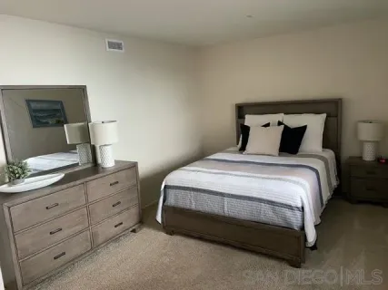 a bedroom with a bed and a dresser