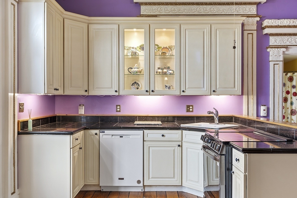 a kitchen with stainless steel appliances granite countertop a sink and cabinets