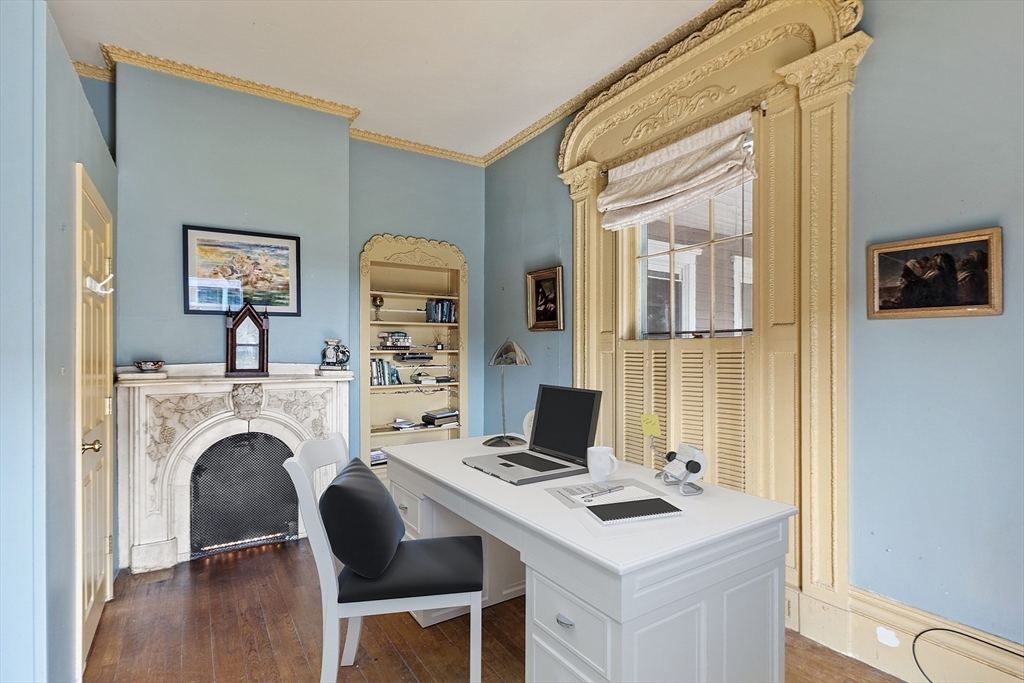 214 3rd Street, Unit A Lowell, MA 01850 - Photo 19 of 32 a view of a workspace with furniture and a fireplace