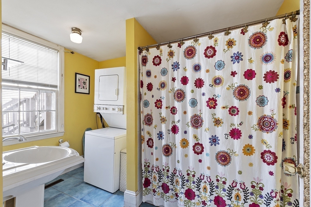 214 3rd Street, Unit A Lowell, MA 01850 - Photo 22 of 32 a bathroom with a bathtub and a shower curtain
