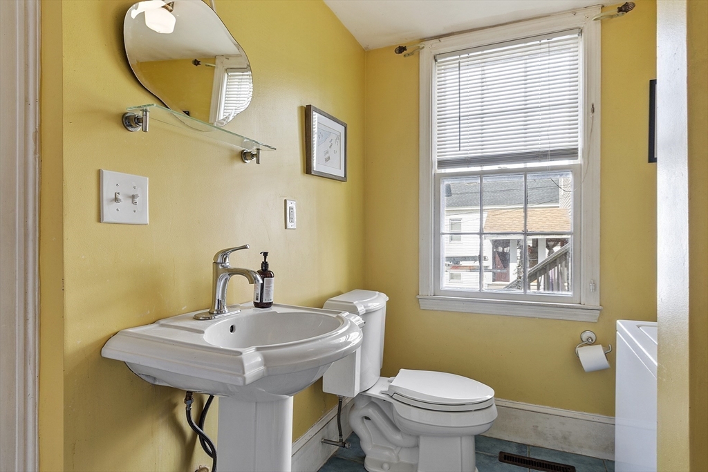 214 3rd Street, Unit A Lowell, MA 01850 - Photo 23 of 32 a bathroom with a sink and a mirror